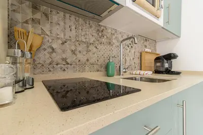 a kitchen with a sink and a counter top at Puertas del Sol 11 in Jerez de la Frontera