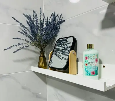 a shelf with a cell phone and a bottle of soap at Puertas del Sol 11 in Jerez de la Frontera