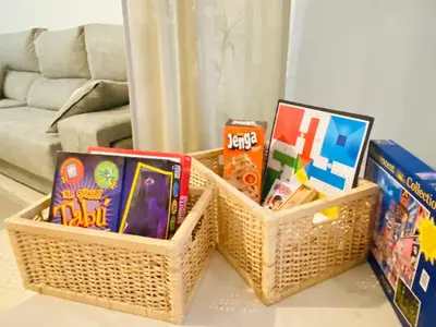 two baskets filled with books and games on a table at Ático Sonnenschein in Jerez de la Frontera