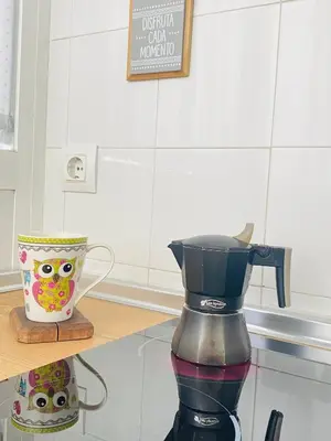 a coffee maker on a counter next to a vase at Ático Sonnenschein in Jerez de la Frontera