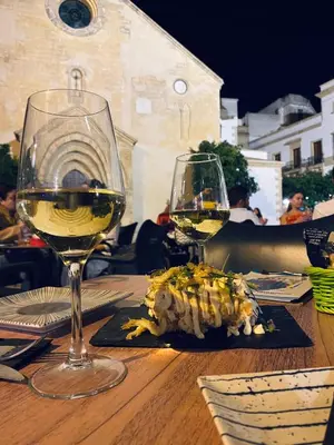 a table with two glasses of white wine on it at Ático Sonnenschein in Jerez de la Frontera