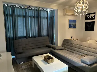 a bed in a room with white walls at Apartamento Valdés in El Puerto de Santa María
