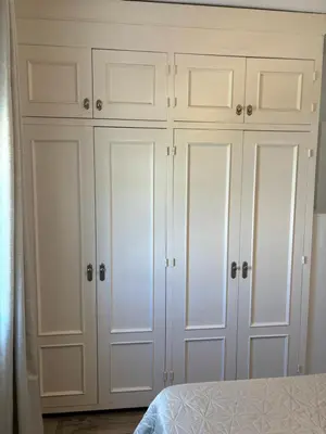 a white closet with white cabinets in a bedroom at Apartamento Valdés in El Puerto de Santa María