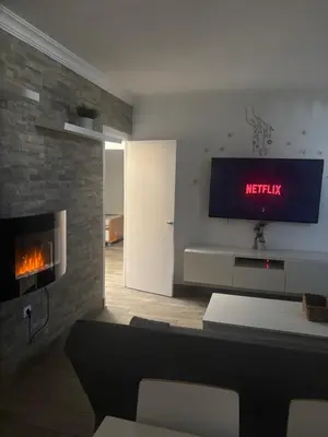 a living room with a couch and a flat screen tv at Apartamento Valdés in El Puerto de Santa María