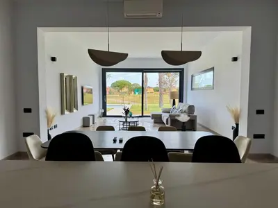 a dining room with a table and chairs at Poniente Beach House in Chiclana de la Frontera