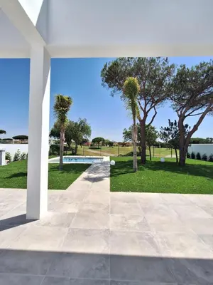 a view from the courtyard of a house with trees at Poniente Beach House in Chiclana de la Frontera