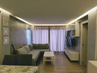 a living room with a couch and a television at Apartamento 3 Dormitorios con Terraza in Jerez de la Frontera