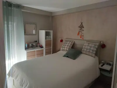 a bedroom with a white bed with two pillows at Apartamento 3 Dormitorios con Terraza in Jerez de la Frontera