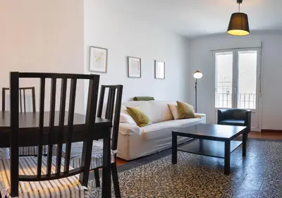 a living room with a couch and a table at Ático Plaza Del Cabildo A 10 Min De La Playa in Sanlúcar de Barrameda