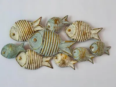 a group of fish on a white wall at GATU Ático Divino 