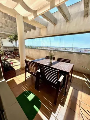 a balcony with a table and chairs in a building at GATU Ático Divino 