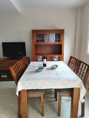 a dining room with a table with two glasses of wine at La Longuera - Playa Cruz del Mar in Chipiona