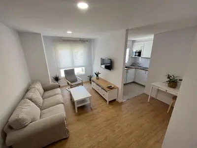 a living room with a couch and a table at Apartamento Chiclana de la frontera in Chiclana de la Frontera
