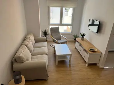 a living room with a couch and a table at Apartamento Chiclana de la frontera in Chiclana de la Frontera
