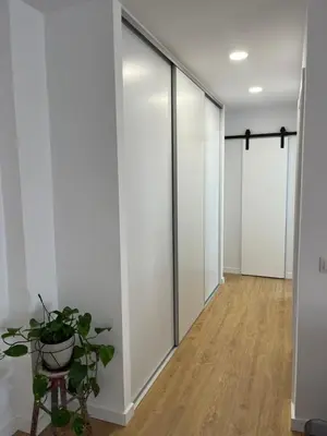 a hallway with sliding glass doors and a plant at Apartamento Chiclana de la frontera in Chiclana de la Frontera
