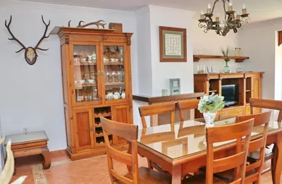 a dining room with a table and chairs and a television at Casa Pradillo in Conil de la Frontera