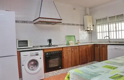 a kitchen with a washing machine and a washer at Casa Pradillo in Conil de la Frontera