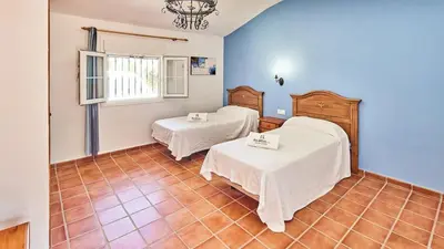 a room with two beds and a window at Villa Alegría Conil de la Frontera by Ruralidays in Conil de la Frontera