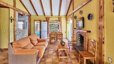 a living room with a couch and a fireplace at Villa Alegría Conil de la Frontera by Ruralidays in Conil de la Frontera
