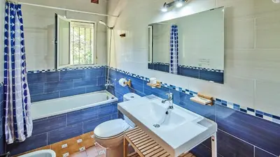 a bathroom with a sink and a toilet and a tub at Villa Alegría Conil de la Frontera by Ruralidays in Conil de la Frontera
