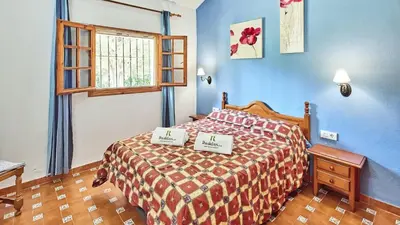 a bedroom with a bed with two signs on it at Villa Alegría Conil de la Frontera by Ruralidays in Conil de la Frontera