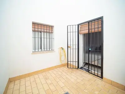 an empty room with a door and windows at Piso Ángel in Sanlúcar de Barrameda
