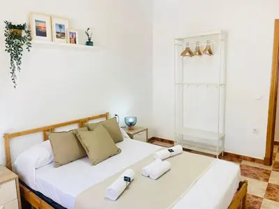 a bedroom with a bed with two towels on it at Entre Pinos in Chiclana de la Frontera