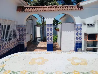 a patio with blue and white tiles on a house at Entre Pinos in Chiclana de la Frontera