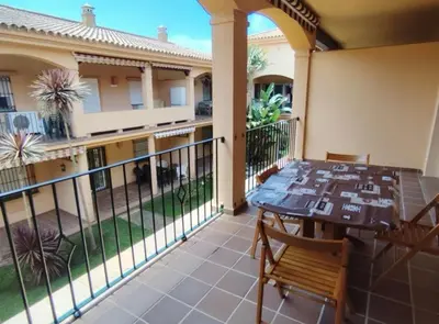 a balcony of a house with a table and chairs at Novo Sancti Petri LUZ DEL NOVO in Novo Sancti Petri