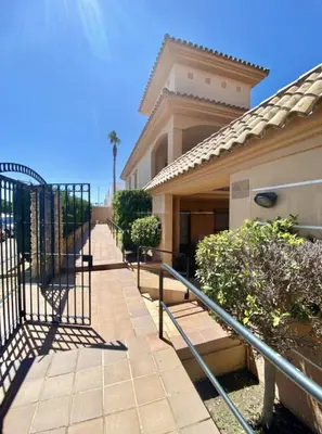 a walkway in front of a house with a gate at Novo Sancti Petri LUZ DEL NOVO in Novo Sancti Petri
