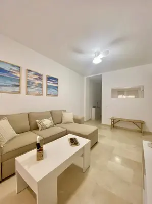a living room with a couch and a table at Novo Sancti Petri LUZ DEL NOVO in Novo Sancti Petri
