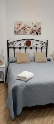 a bedroom with a large bed with two pillows on it at Duplex Las Torres a 700m Playa in Chiclana de la Frontera