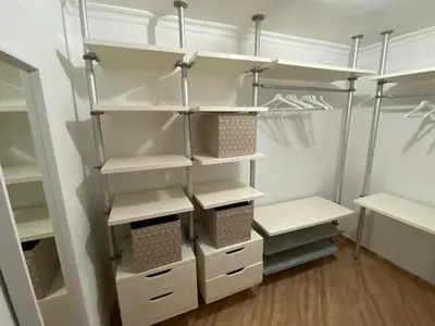 a walk in closet with white cabinets and shelves at Duplex Las Torres a 700m Playa in Chiclana de la Frontera