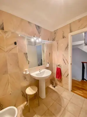 a bathroom with a white sink and a mirror at Amplio adosado a pocos metros de la playa in Poblado de Sancti Petri