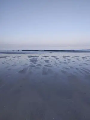 a view of a beach with clouds in the water at Apartamento Cata in El Puerto de Santa María