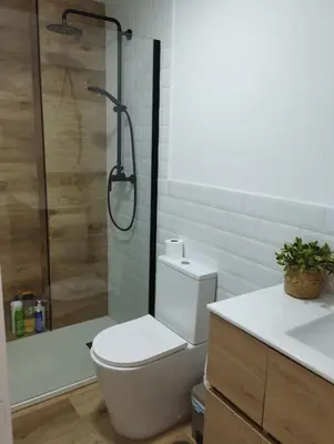 a bathroom with a shower and a toilet and a sink at Apartamento Cata in El Puerto de Santa María