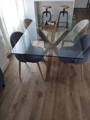 a glass table and chairs in a living room at Apartamento Cata in El Puerto de Santa María