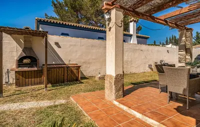 a patio with a pizza oven in a backyard at Nice Home In Chiclana De La Fronter in Novo Sancti Petri