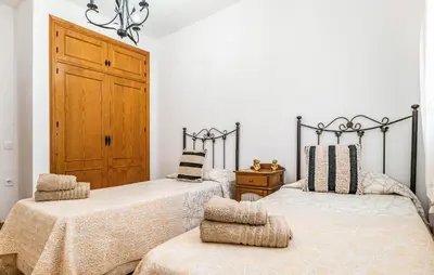 two beds sitting next to each other in a bedroom at Nice Home In Chiclana De La Fronter in Novo Sancti Petri