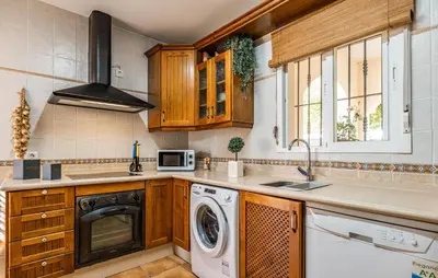 a kitchen with a washer and a dishwasher at Nice Home In Chiclana De La Fronter in Novo Sancti Petri