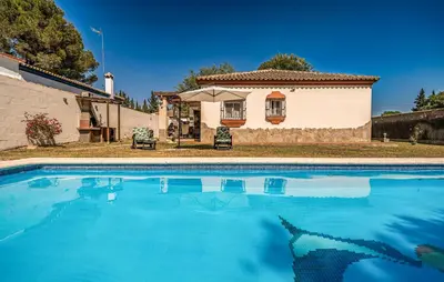 a swimming pool in front of a house at Nice Home In Chiclana De La Fronter in Novo Sancti Petri