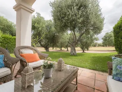 a patio with wicker chairs and a table with a view at Holiday Home Arcos Gardens Golf by Interhome in Arcos de la Frontera
