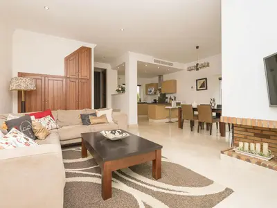 a living room with a couch and a table at Holiday Home Arcos Gardens Golf by Interhome in Arcos de la Frontera