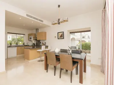 a kitchen and dining room with a table and chairs at Holiday Home Arcos Gardens Golf by Interhome in Arcos de la Frontera