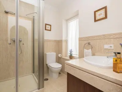 a bathroom with a toilet and a sink and a shower at Holiday Home Arcos Gardens Golf by Interhome in Arcos de la Frontera