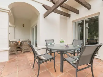 a dining room with a glass table and chairs at Holiday Home Arcos Gardens Golf by Interhome in Arcos de la Frontera