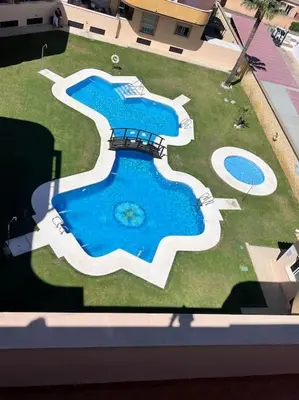 an aerial view of a swimming pool in the grass at Apartamento Mirador del Coto in Sanlúcar de Barrameda