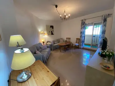a living room with a couch and a table at Apartamento Mirador del Coto in Sanlúcar de Barrameda