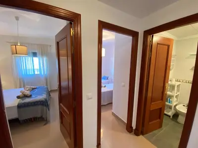 a room with a bedroom with a bed and a bathroom at Apartamento Mirador del Coto in Sanlúcar de Barrameda