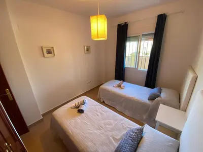 a living room with two beds and a couch at Apartamento Mirador del Coto in Sanlúcar de Barrameda